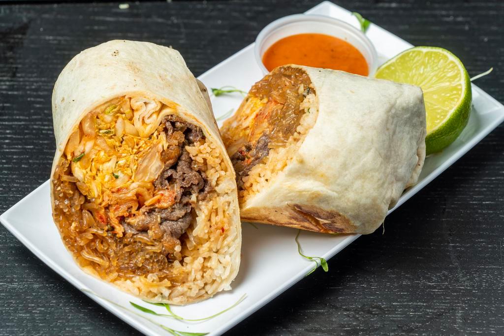 Bulgogi (Ribeye) Burrito · Thinly Sliced Ribeye Beef marinated in a Sweet Soy, Garlic, Onions, and Green Onions.  Wrapped in our Cilantro-Lime Rice, Sweet Potato Noodles (Chap-Chae), Queso, TaKorea Greens, Kimchi, and choice sauce/salsa on side
