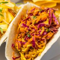 Curry Chicken Tinga Taco · Chicken breast slow cooked in Chipotle with Adobo, tomatoes and onions, and then braised in ...