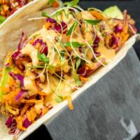 Fried Chicken Taco · Fried chicken topped with Asian slaw, avocado, and yuzu elote dressing.  Served in our Gordi...