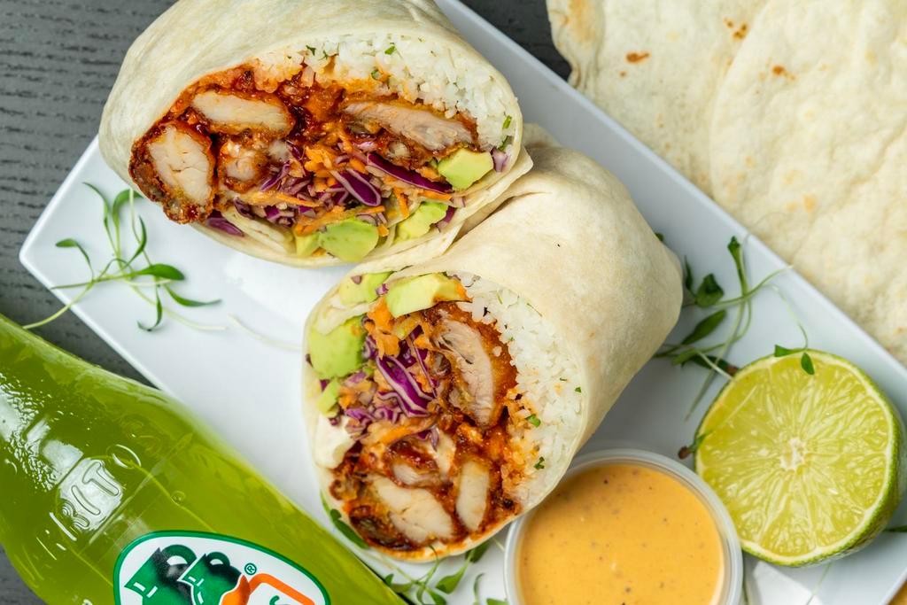 Fried Chicken Burrito · Korean-style twice Fried Chicken.  Wrapped with our Cilantro-Lime Rice, Queso,  Avocado, and Asian Slaw.  Choice of side salsa.