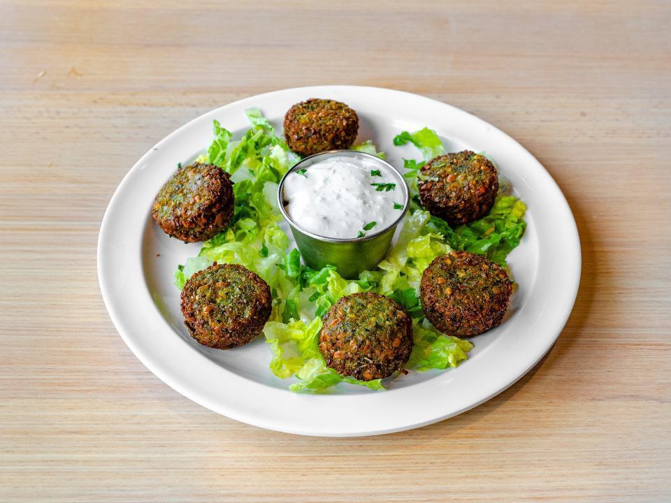 Falafel appetizer · pan fried croquettes of ground chickpeas, onion, and  herbs served with tzatziki
*GF* *VEGETARIAN* 
*VEGAN if tzatziki substituted for hummus