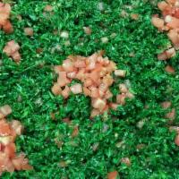 Taboull Salad · Finely chopped parsley with cracked wheat, tomatoes, onions, mint, olive oil, and lemon juice.