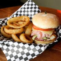 Chicken Malibu Sandwich · Grilled chicken breast topped with ham and Swiss cheese. Served with pickle, onion, lettuce ...