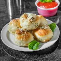 Garlic Knots · Rolled baked garlic bread. Add side of sauce for an additional charge.