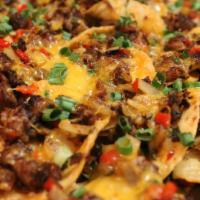 Macho Nacho · Chips topped w/ Home made Beef Chili, Melted Sharp Cheddar Cheese & Sliced Jalapeno.