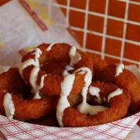 Buffalo Onion Rings · Onion rings tossed in Frank's Buffalo Sauce with bleu cheesedressing on the side..