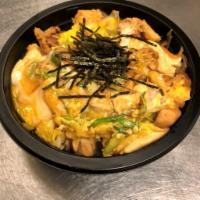 Chicken Oyako Don · Cooked with soy dashi, onion, nori seaweed, and eggs all over rice. 