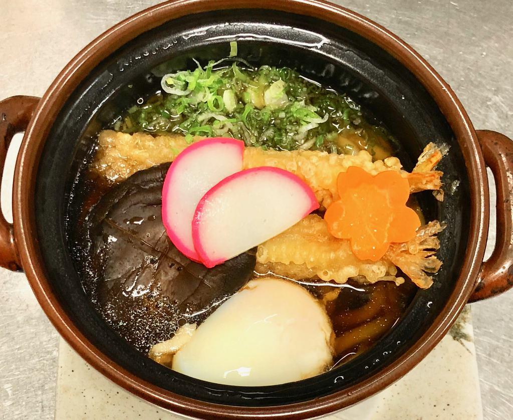 Nabe Yaki Udon · Udon noodle soup with shrimp tempura, fish cake, shiitake, poached egg, and scallion.
Comes with onigiri rice ball and pickles.