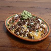 Nachos · Served with meat, beans, nacho cheese, jalapeno, guacamole, sour cream, pico de gallo and Co...