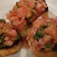Bruschetta · diced fresh tomato, red onions and basil over sliced toasted bread