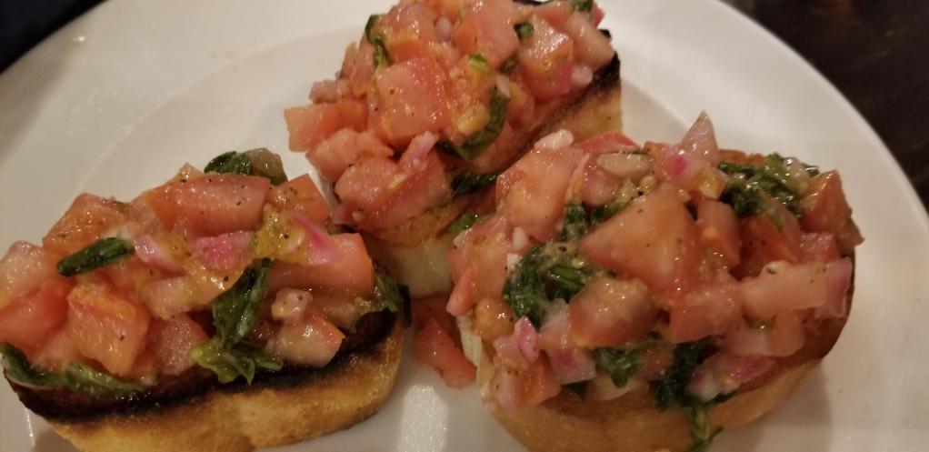 Bruschetta · diced fresh tomato, red onions and basil over sliced toasted bread