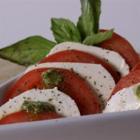 Caprese Salad · Italian salad made of sliced fresh mozzarella, tomatoes, and sweet basil, seasoned with salt...