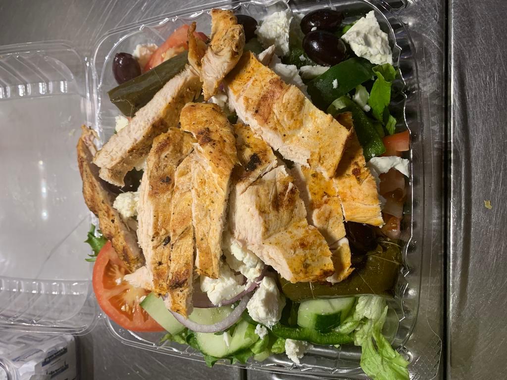 Classic Greek Salad · Wedged tomatoes, lettuce, feta cheese, anchovies, Kalamata olives, peppers, onions and stuffed grape leaves, with extra virgin olive oil & aged wine vinegar. Served with toasted pita.
