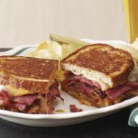 New York Reuben · Choice of corned beef or pastrami with sauerkraut and melted Swiss cheese on grilled rye bre...