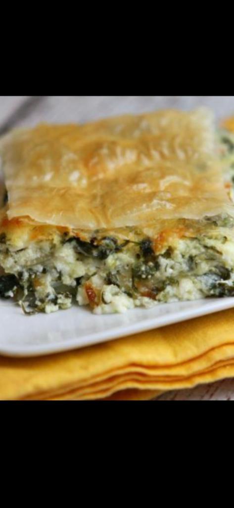 Spanakopita · Spinach pie with feta cheese and spinach leaf baked to a golden brown in phyllo dough. Served with Greek salad