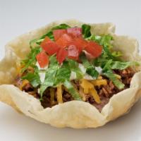 Tostada Delight · A crisp flour tortilla bowl filled with fat-free pinto beans, seasoned ground beef, cheddar ...