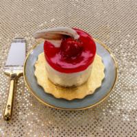 Personal Strawberry Cheesecake · Cheesecake covered in red strawberry glaze with chocolate garnish.