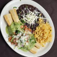 Lilly's Flautas · Garnished with lettuce, pico de gallo, and guacamole sauce topped with parmesan and served w...