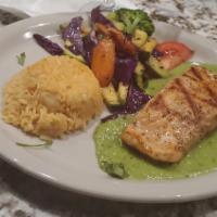 Salmon Verde · Grilled salmon topped with avocado sauce, served with Julianne vegetables and rice.