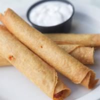 Taquitos · 4 taquitos. Crispy corn tortillas, stuffed with seasoned chicken, and served with sour cream...