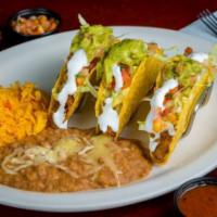 Loaded Tacos · 3 tacos. Topped with lettuce, pico de gallo, guacamole, cheese, and sour cream. Served with ...