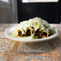 Taquitos Dorados · A deep fried corn tortilla stuffed with chicken, beef or pork, sour cream, guacamole, lettuc...