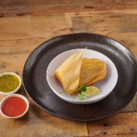 Tamales · Pollo con Mole, pollo con salsa verdes green or rajas con queso.  Vegetarian.