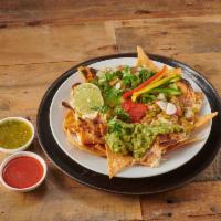 Nachos · Fresh homemade chips with refried pinto beans, served with pico de gallo, guacamole, melted ...