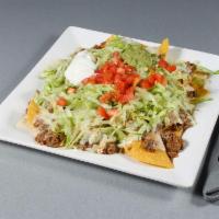 Special Nachos Supreme · Topped with ground beef, lettuce, tomato, sour cream and guacamole.