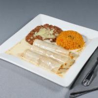 Enchiladas con Crema Lunch · 2 chicken enchiladas topped with our special sour cream cheese sauce with rice and beans.