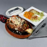 Pineapple Loca Fajita · Steak, chicken and shrimp cooked with pineapple, bell peppers and onions, topped with cheese...