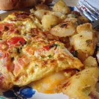 Italian Omelette · Prosciutto, tomatoes, onion, pepper, mozzarella cheese. Served with choice of fries and toast.