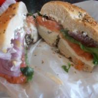 Lox Deluxe Bagel · Bagel with Cream cheese and fresh lox served with red onion and tomatoes