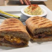 Philadelphia Hero · grilled steak with onion, mushrooms and Vermont cheddar and peter Luger sauce on a toasted g...