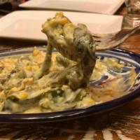 Rajas con Crema · Strips of roasted poblano peppers, corn with Mexican cream, and cheese.