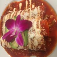 Enchiladas Rancheras · 3 soft tortillas with extra spicy marinated beef in guajillo sauce. Served with rice and bea...