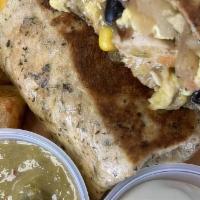 Vegetarian Breakfast Burrito · Eggs, cremini mushrooms, black beans, tomatoes, onions, tater tots, bell peppers, cheddar ch...