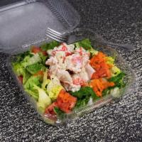 Seafood Salad · A delicious blend of seafood tops our classic garden salad.
