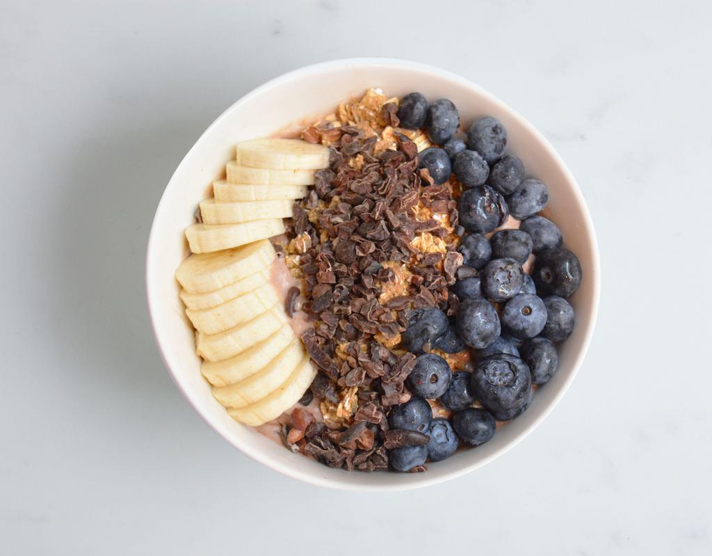 PB&C Acai Bowl · Coconut milk, bananas, peanut butter, cacao powder. Topped with granola, bananas, blueberries and cacao nibs.