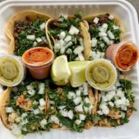 Tacos · Choice of meat. Topped with cilantro and onions served on a corn tortilla.

