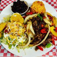 Fajita Plate · Grilled Bell Peppers and Onions, choice of meat, Tofu or Veggie pastor (Marinated soy). Rice...