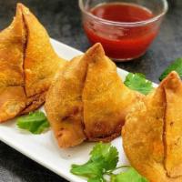 Samosas Sorcerer · Crispy turnovers with seasoned potatoes green peas, and spices.

