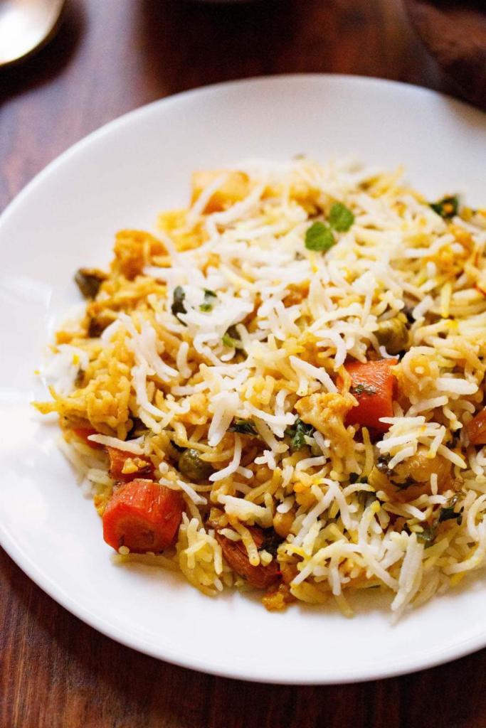 Vegetable Biryani Hyderabadi · Basmati rice cooked with fresh mixed vegetables cumin seeds, curry leaves, mustard seeds, and exotic herbs.
