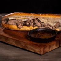 The French Dip Sandwich · Home-made roast beef with provolone cheese and horseradish sauce dipped in au jus.