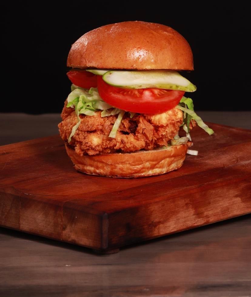 The Crispy Chicken Sandwich · Buttermilk soaked chicken fried with lettuce, tomato house-made pickles, and lemon aioli.