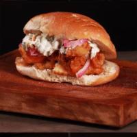 Fried Fish Sandwich · Beer battered cod filet fried topped with pickled onions, fresh coleslaw, and tartar sauce.