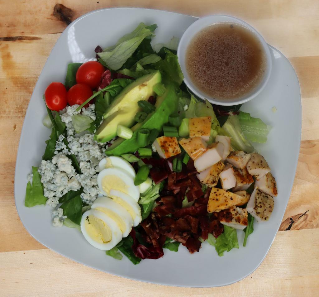 Cobb Box Lunch · Mixed greens, hard boiled eggs, bacon bits, cherry tomatoes, avocado, blue cheese, green onions and grilled lemon pepper chicken, with red wine honey dijon vinaigrette.