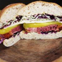 Pastrami Sandwich Box Lunch · Sliced corn beef pastrami, cabbage, pickles, Swiss cheese, on a rye baguette with honey must...