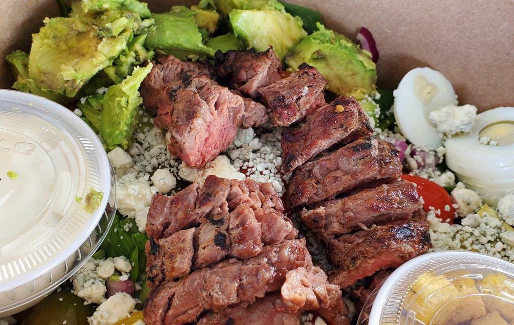 Steak and Spinach Salad  · Spinach, blue cheese crumble, red onion, bacon, tomato, avocado, 5 oz steak, and egg.