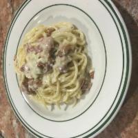 Pasta Carbonara · White cream sauce with onions and bacon.